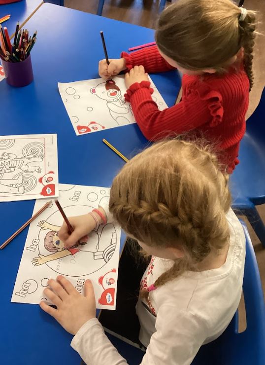 Two children colouring in.